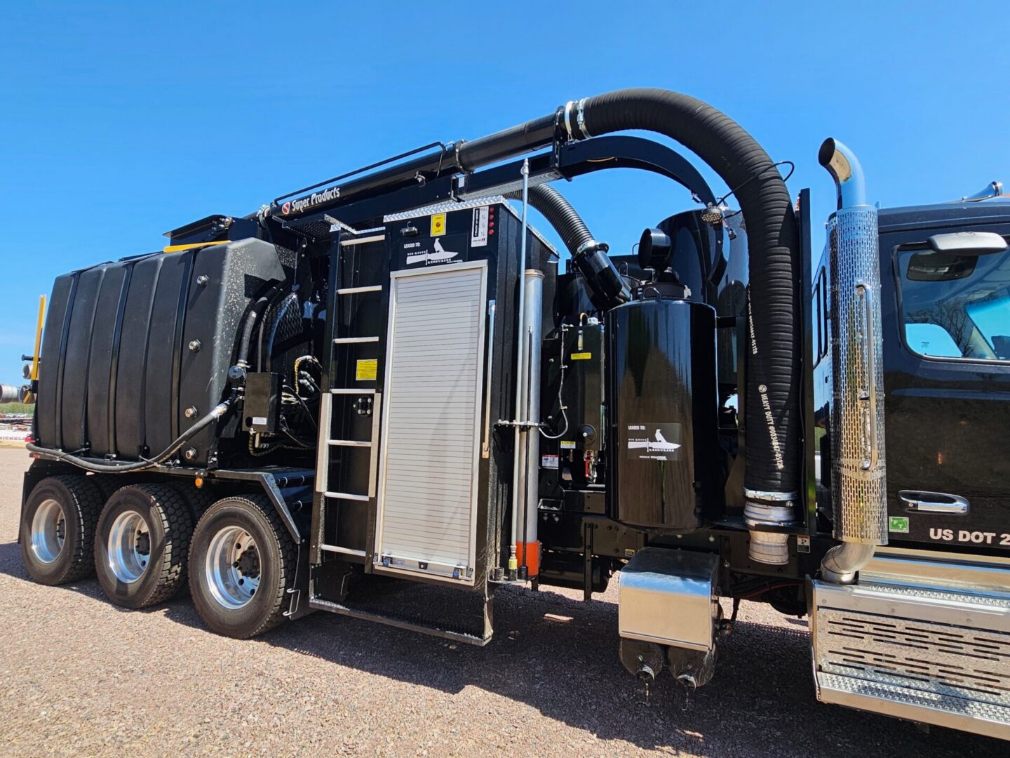 Industrial vacuum truck with hose and ladder